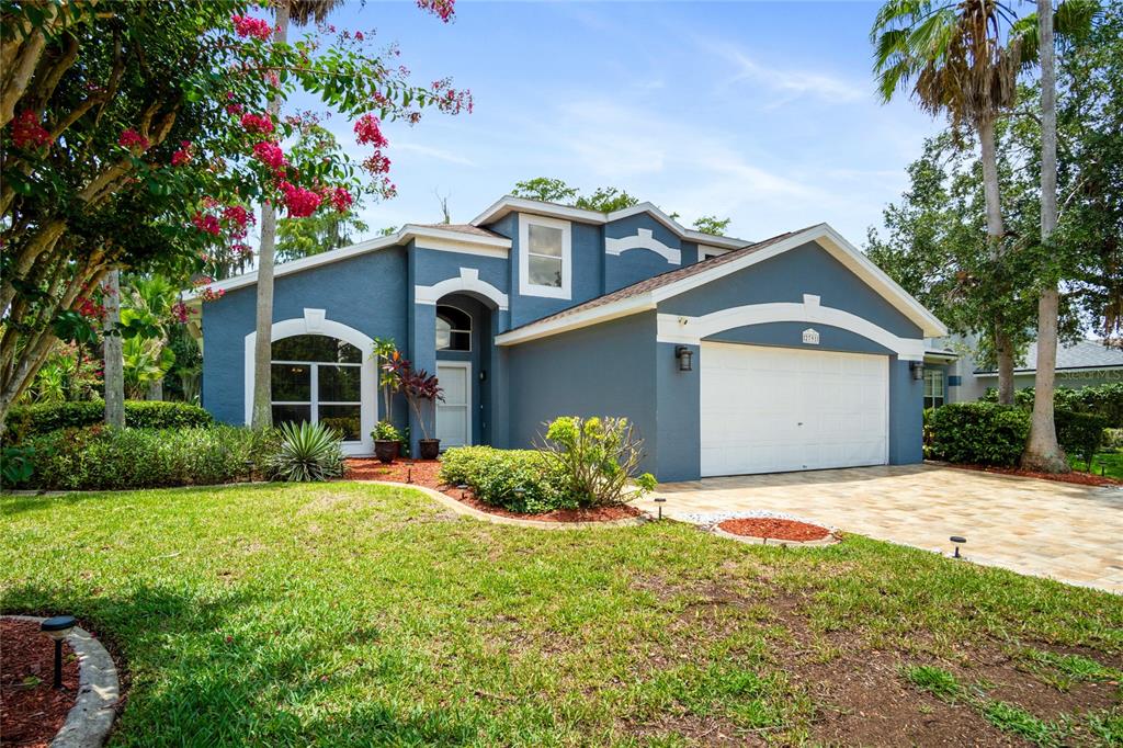 A blue single-story house with a white garage door and a paved driveway — 2791 RUNYON CIRCLE, ORLANDO, FL