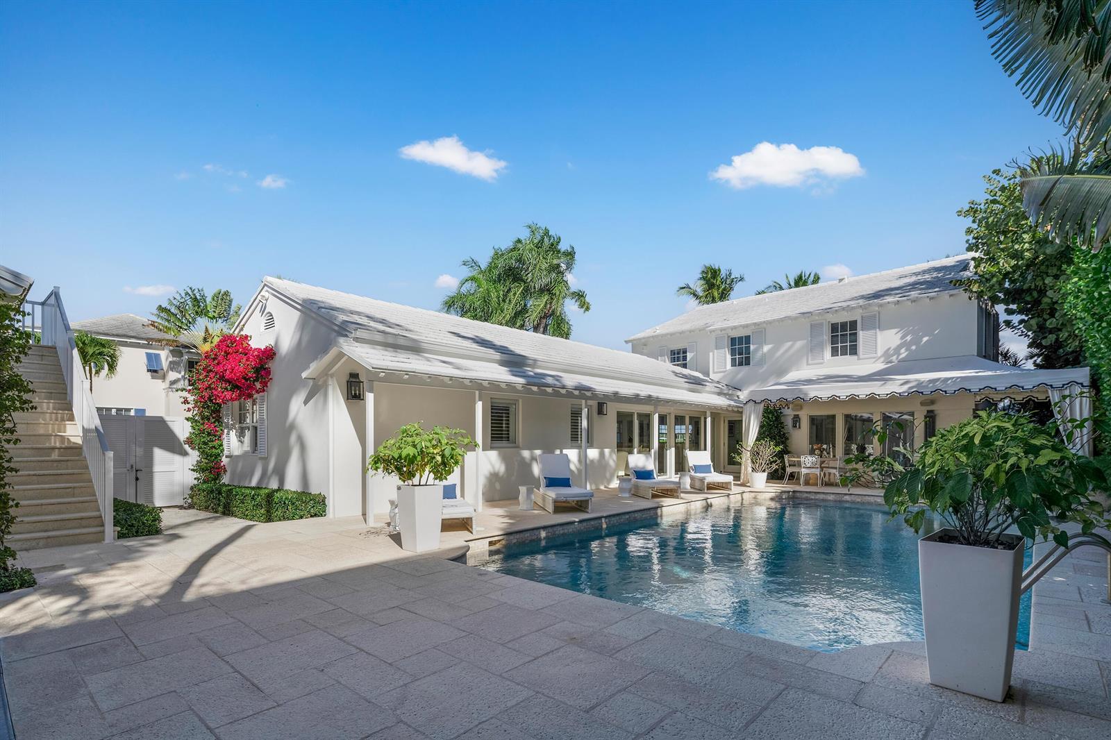 A white two-story house with a swimming pool and patio area under a blue sky — 7103 S Flagler Drive, West Palm Beach FL 33405, WEST PALM BEACH, FL