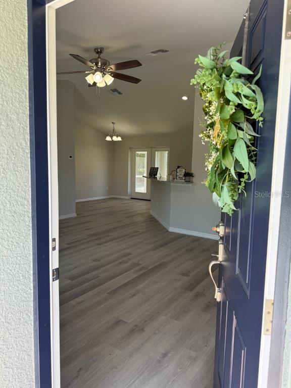 A single-story house with a gray exterior, a two-car garage, and a large front lawn — 13330 SW 111 LANE, DUNNELLON, FL