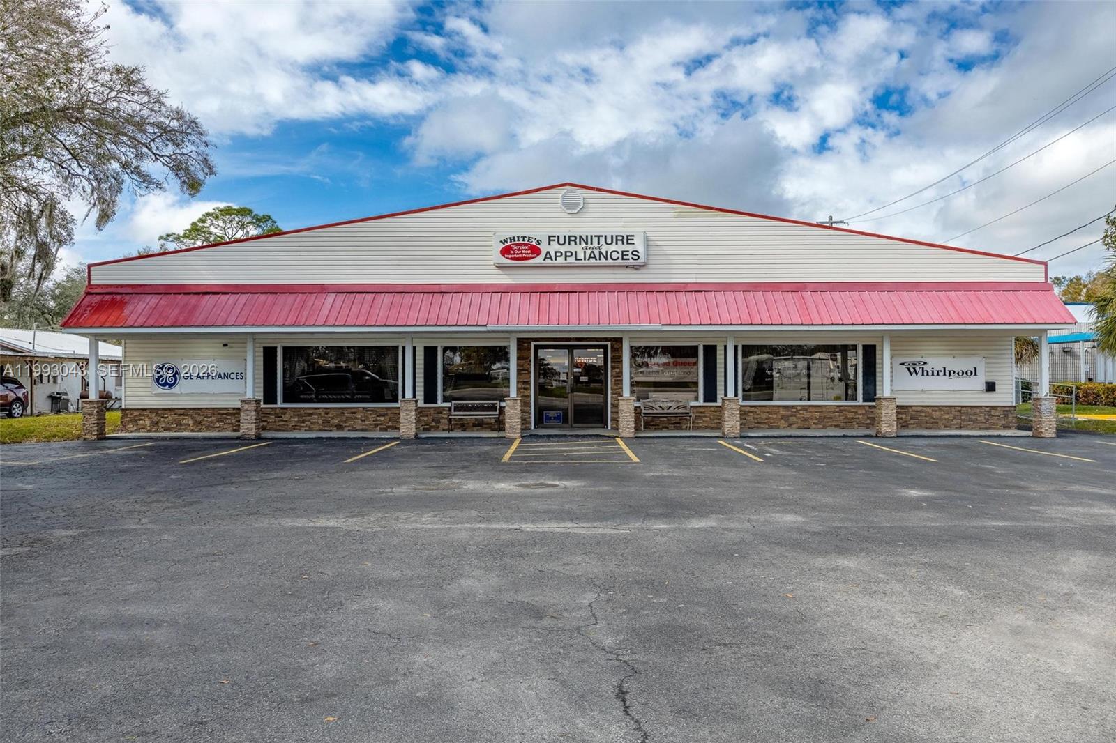 A single-story commercial building with a red metal roof and a paved parking lot — 1060 SR 29 S, La Belle FL 33935, LA BELLE, FL