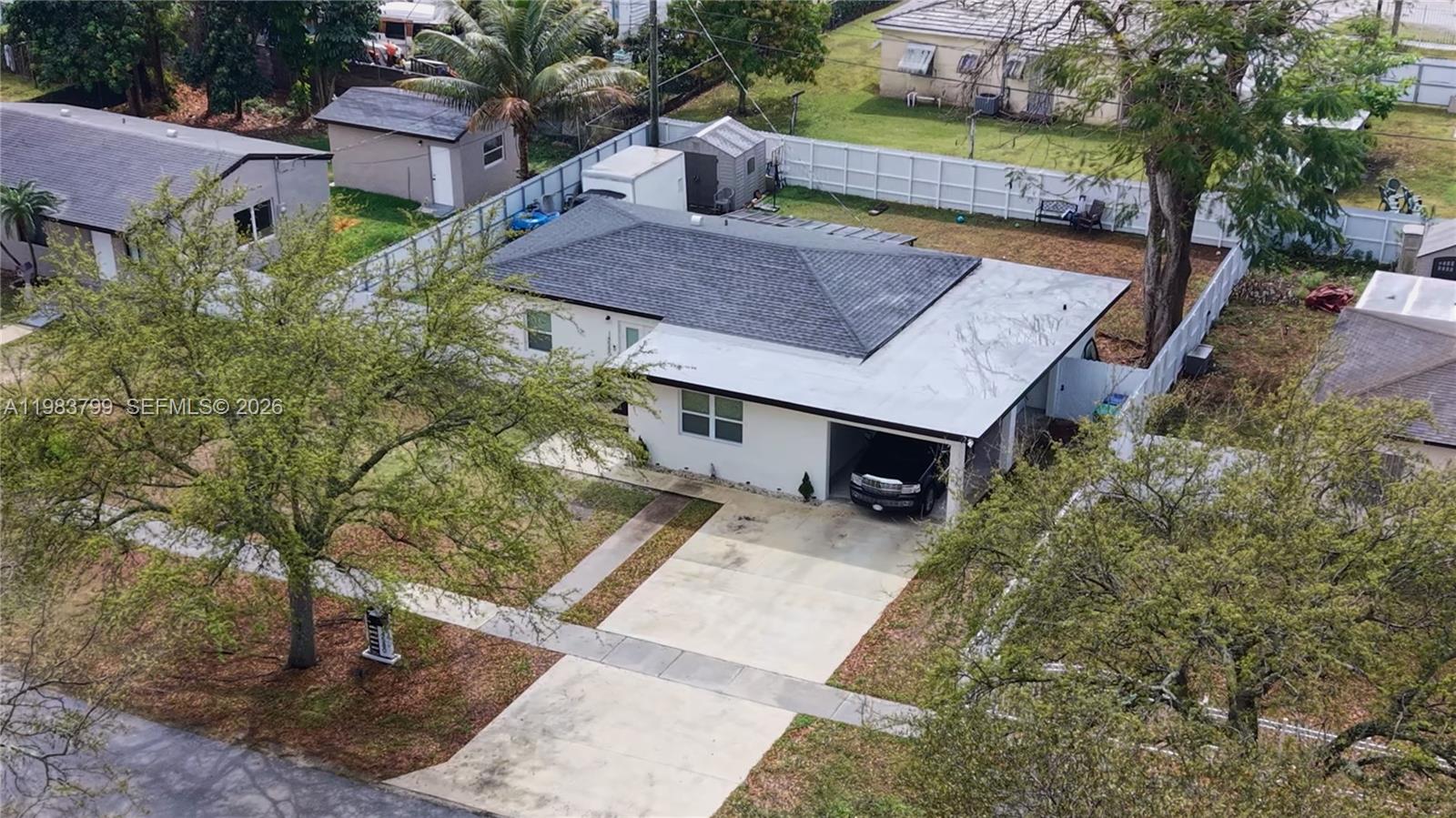 An aerial view shows a single-story house with a driveway, carport, and fenced backyard — 14580 Harrison St, Miami FL 33176, MIAMI, FL