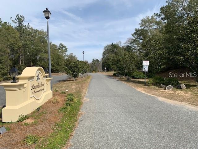 A sign for Magnolia Forest stands at the entrance to a paved residential road — 167 SPARKLEBERRY BOULEVARD, QUINCY, FL