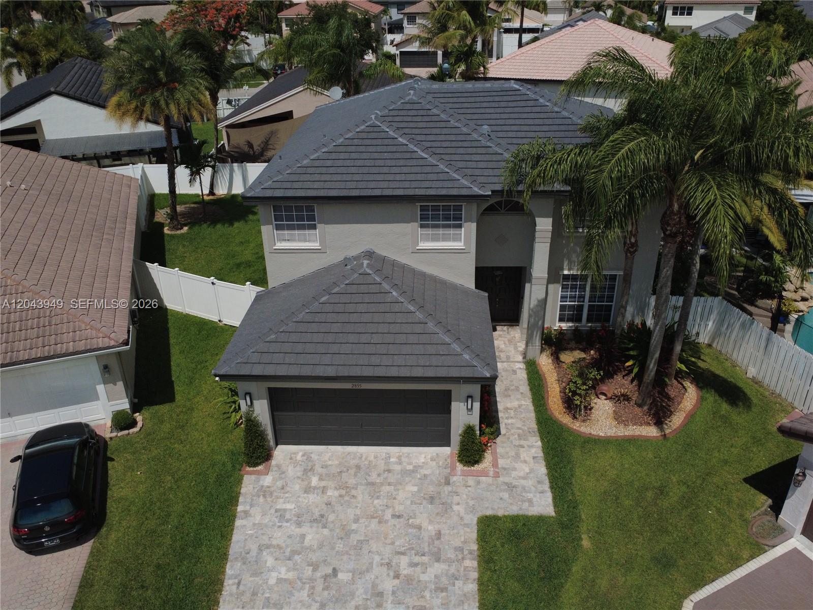 An aerial view shows a two-story house with a gray tiled roof and paver driveway — 2855 SW 177th Ter, Miramar FL 33029, MIRAMAR, FL