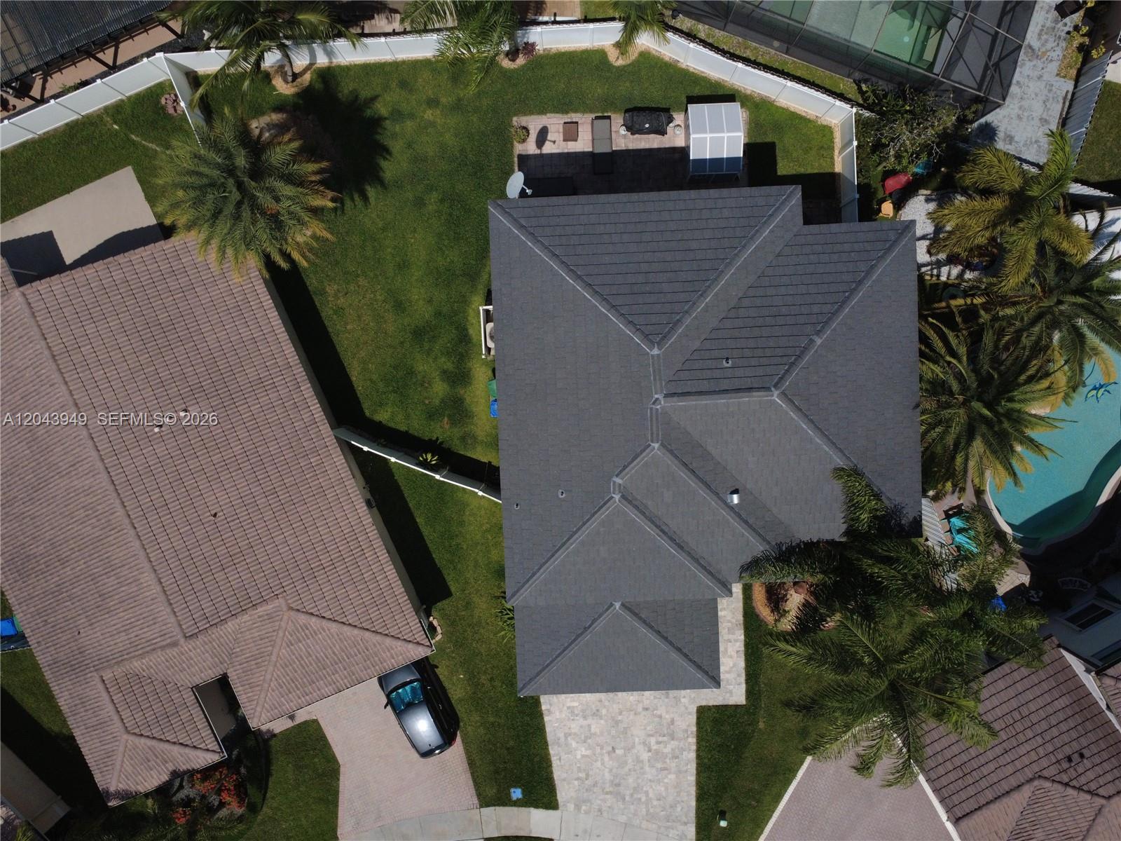 An aerial view shows two houses with shingled roofs, driveways, and backyards with palm trees — 2855 SW 177th Ter, Miramar FL 33029, MIRAMAR, FL