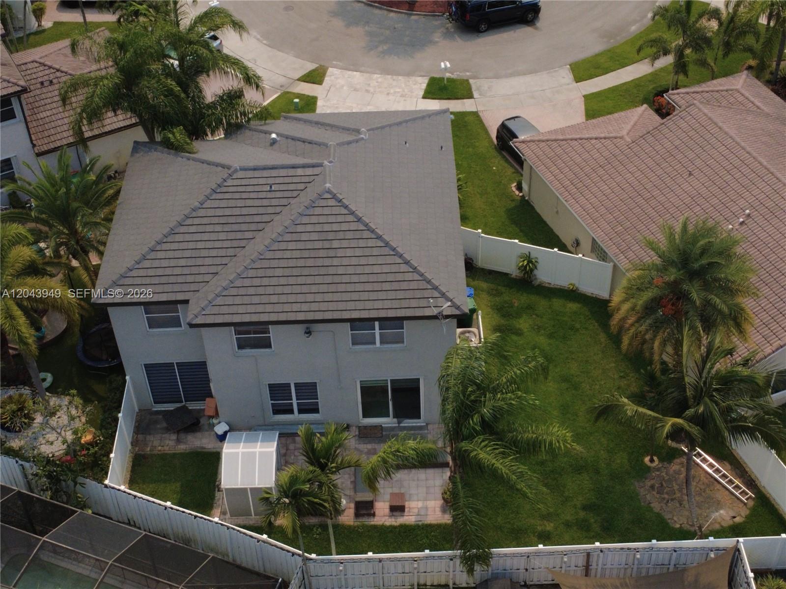 An aerial view shows the rear exterior of a two-story house with a tiled roof — 2855 SW 177th Ter, Miramar FL 33029, MIRAMAR, FL