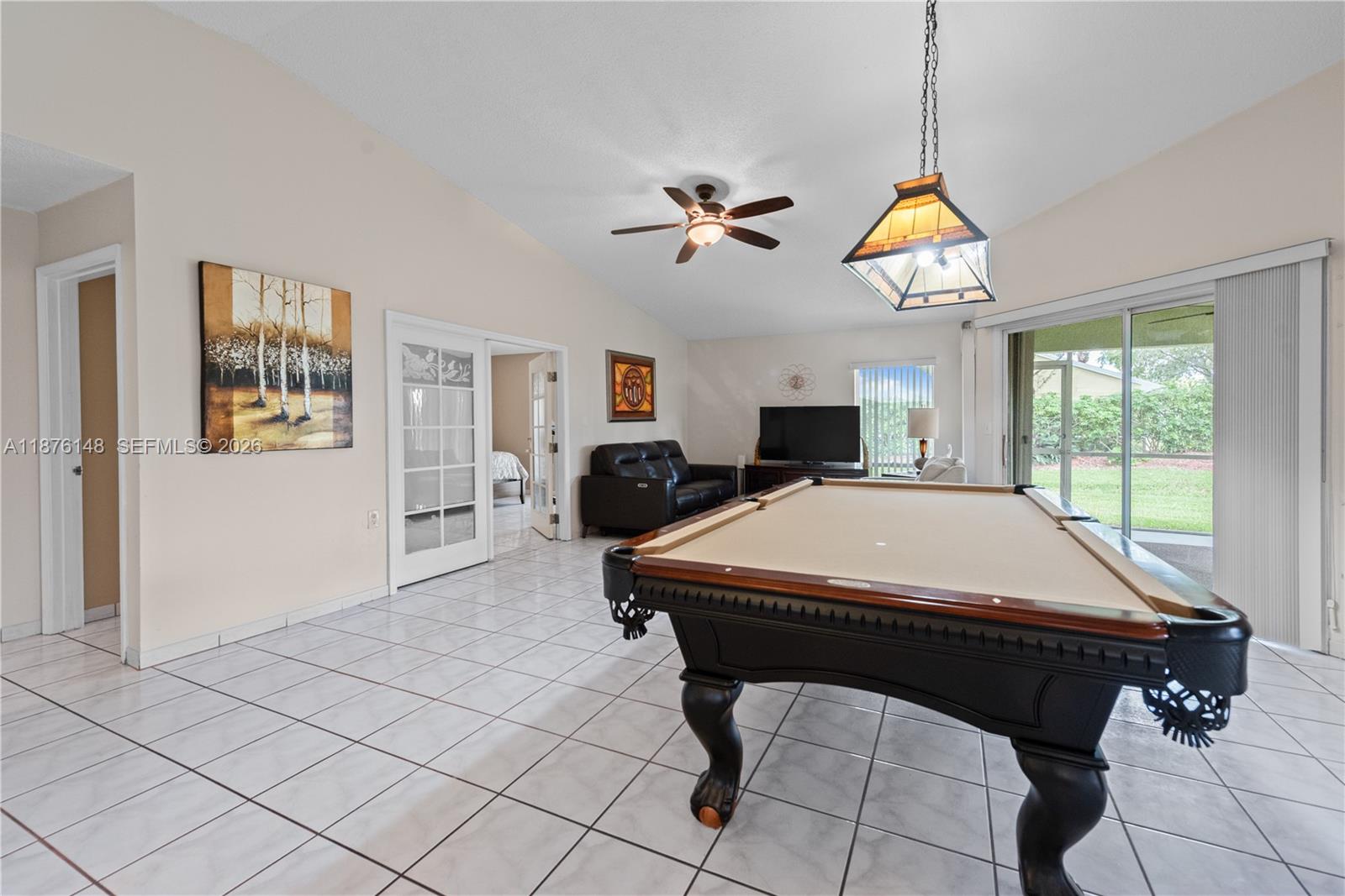 A game room features a pool table, tile flooring, a ceiling fan, and sliding glass doors — 2585 SE 7th Pl, Homestead FL 33033, HOMESTEAD, FL