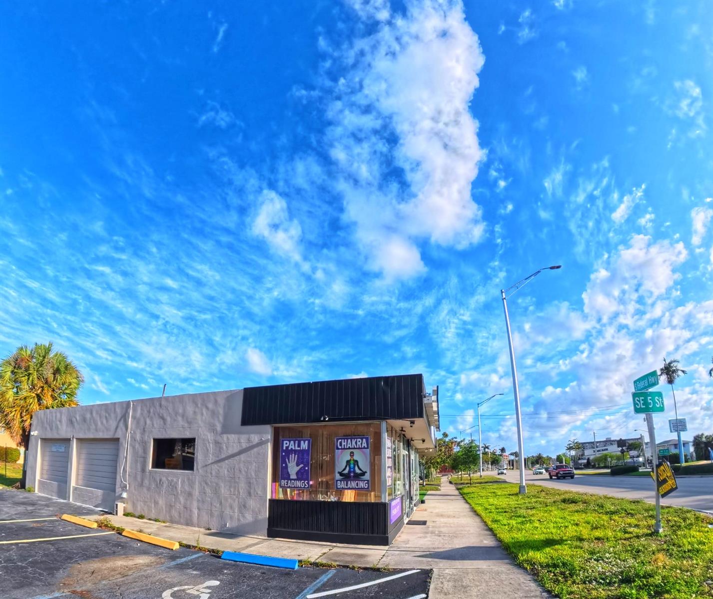 A corner commercial building with palm reading and chakra balancing signage sits beside a road — 520-580 S Federal Highway, Pompano Beach FL 33062, POMPANO BEACH, FL