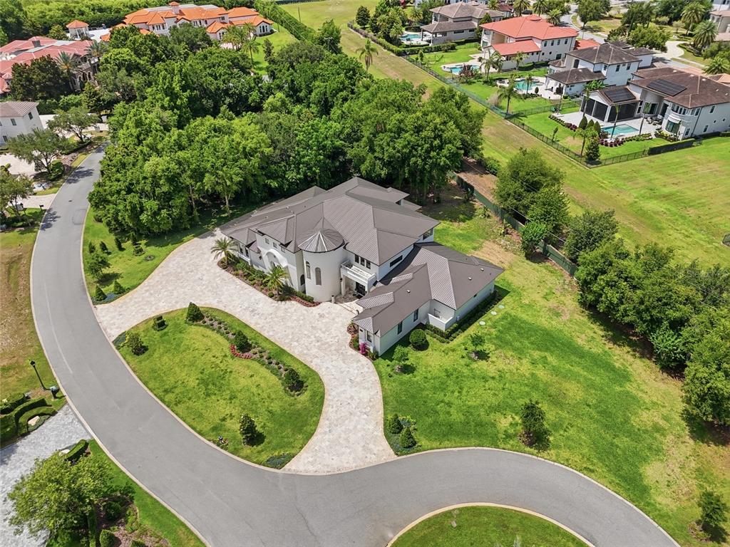 An aerial view shows a large house with a dark roof and stone driveway — 12623 PARK AVENUE, WINDERMERE, FL