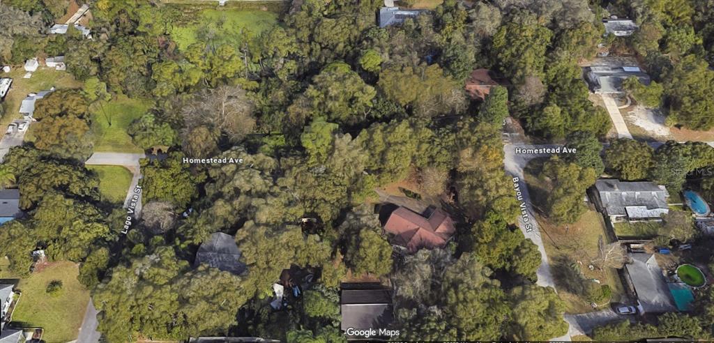 This aerial map view shows a wooded residential area with houses, streets, and dense trees — 122 HOMESTEAD AVENUE, DEBARY, FL