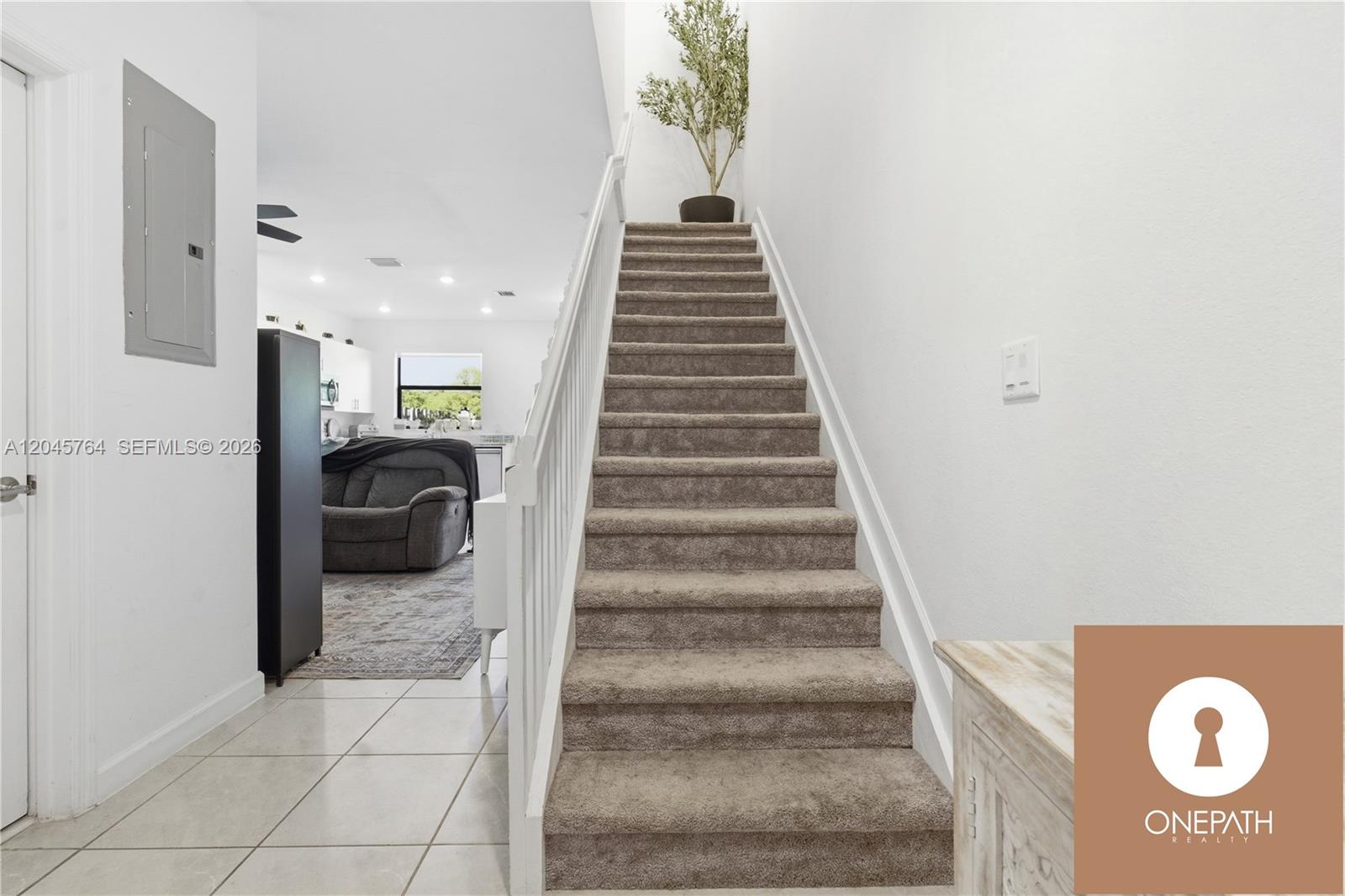 A carpeted staircase leads to an upper level in a home with tiled floors — 23101 SW 99th Ave, Cutler Bay FL 33190, CUTLER BAY, FL