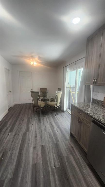 A dining area with a glass table and four chairs sits next to a kitchen — 2545 STRATFORD DRIVE, COCOA, FL