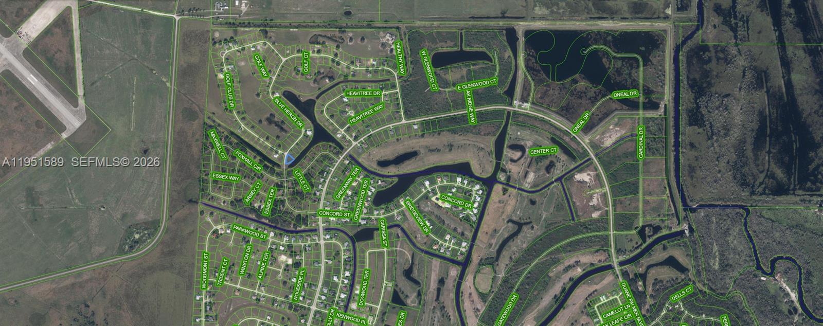 This is an aerial map showing a residential neighborhood with winding streets and water features — 1544 Blue Heron Drive, Sebring FL 33876, SEBRING, FL