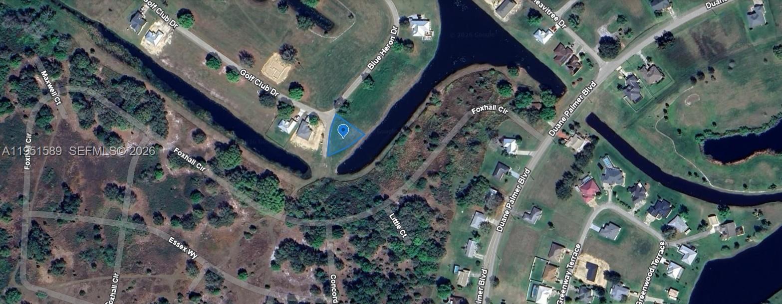 This aerial map shows a vacant triangular lot situated between two bodies of water — 1544 Blue Heron Drive, Sebring FL 33876, SEBRING, FL
