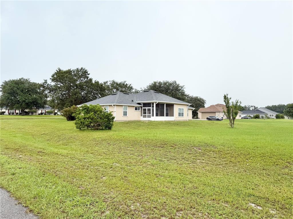 A kitchen features light wood cabinets, stainless steel appliances, and beige laminate countertops — 10144 SW 98 TERRACE, GAINESVILLE, FL