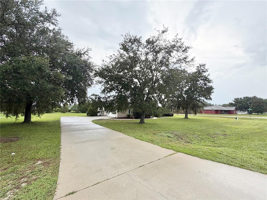 A kitchen features wood cabinets, stainless steel appliances, and tile flooring — 10144 SW 98 TERRACE, GAINESVILLE, FL