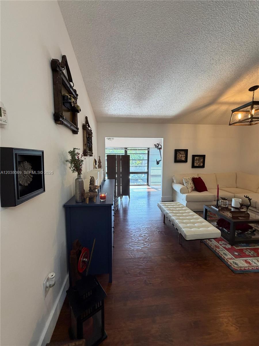 A living room features dark wood flooring, a white sectional sofa, and a blue console table — 4944 NW 102nd Ave # 3, Doral FL 33178, DORAL, FL
