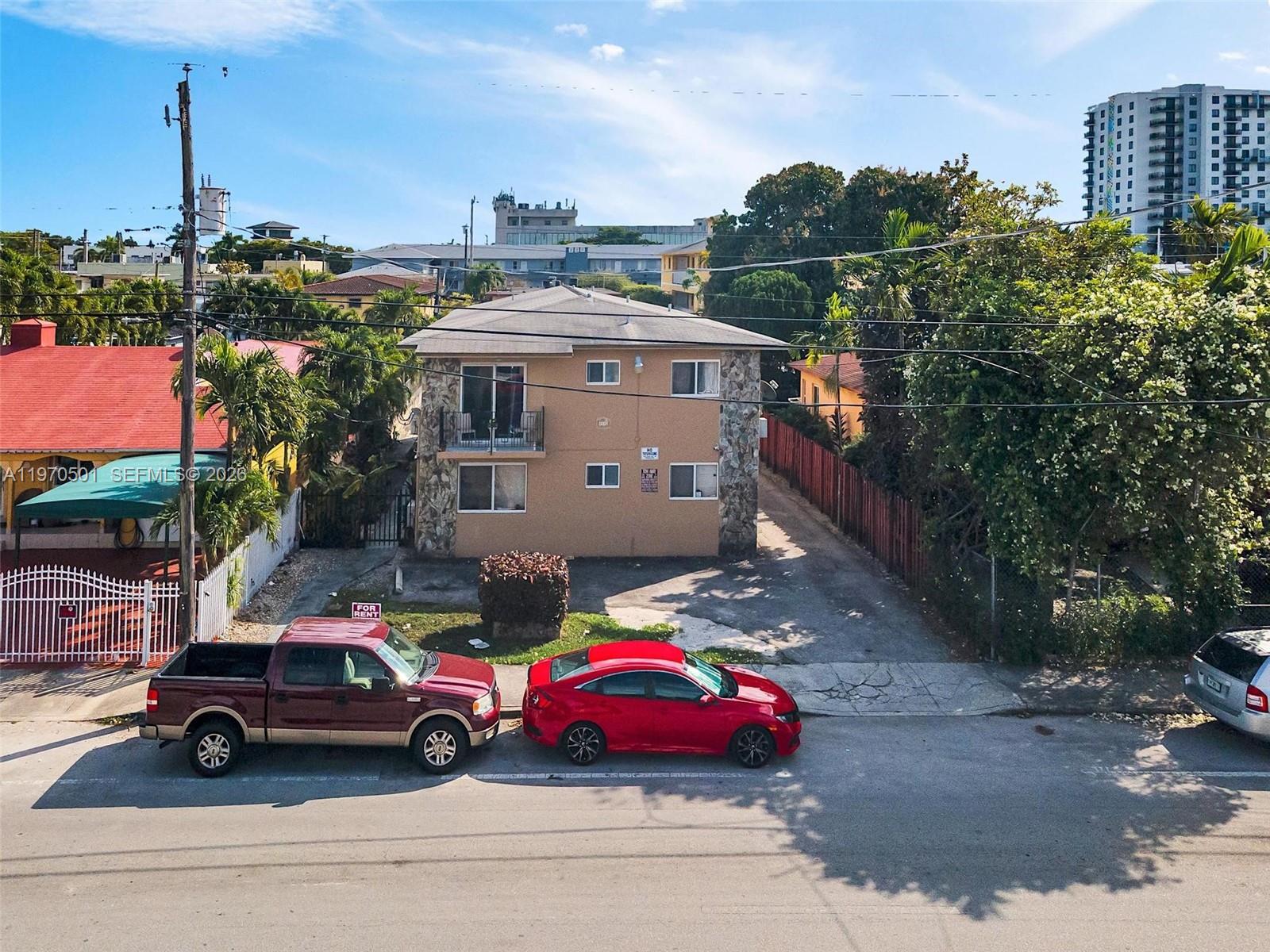 A two-story apartment building with a stone-accented facade sits behind two parked cars — 1836 SW 6th St, Miami FL 33135, MIAMI, FL