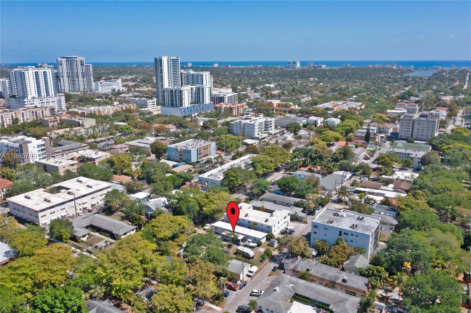 An aerial view shows a residential neighborhood with a red location pin over a building — 1946 Madison St, Hollywood FL 33020, HOLLYWOOD, FL