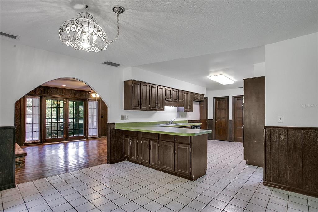 A kitchen with dark wood cabinets, a green countertop, and tiled flooring — 3629 LAKE BUYNAK ROAD, WINDERMERE, FL