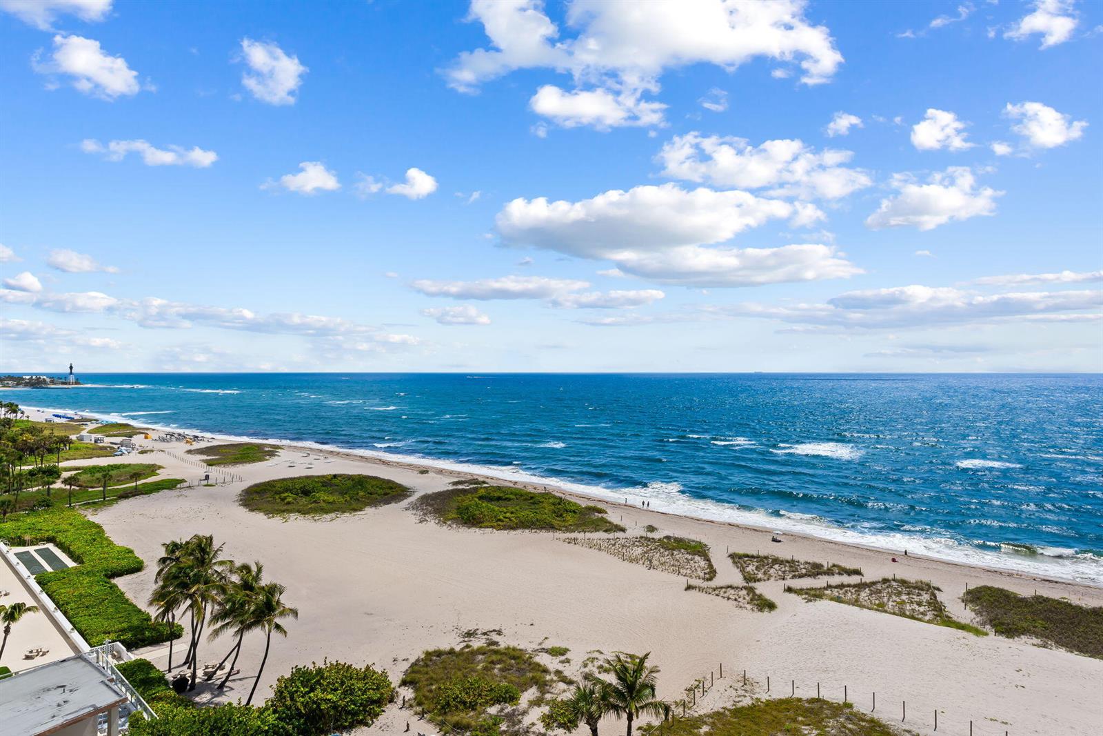 An elevated view of a sandy beach with palm trees and the ocean — 900 N Ocean Boulevard # 906, Pompano Beach FL 33062, POMPANO BEACH, FL