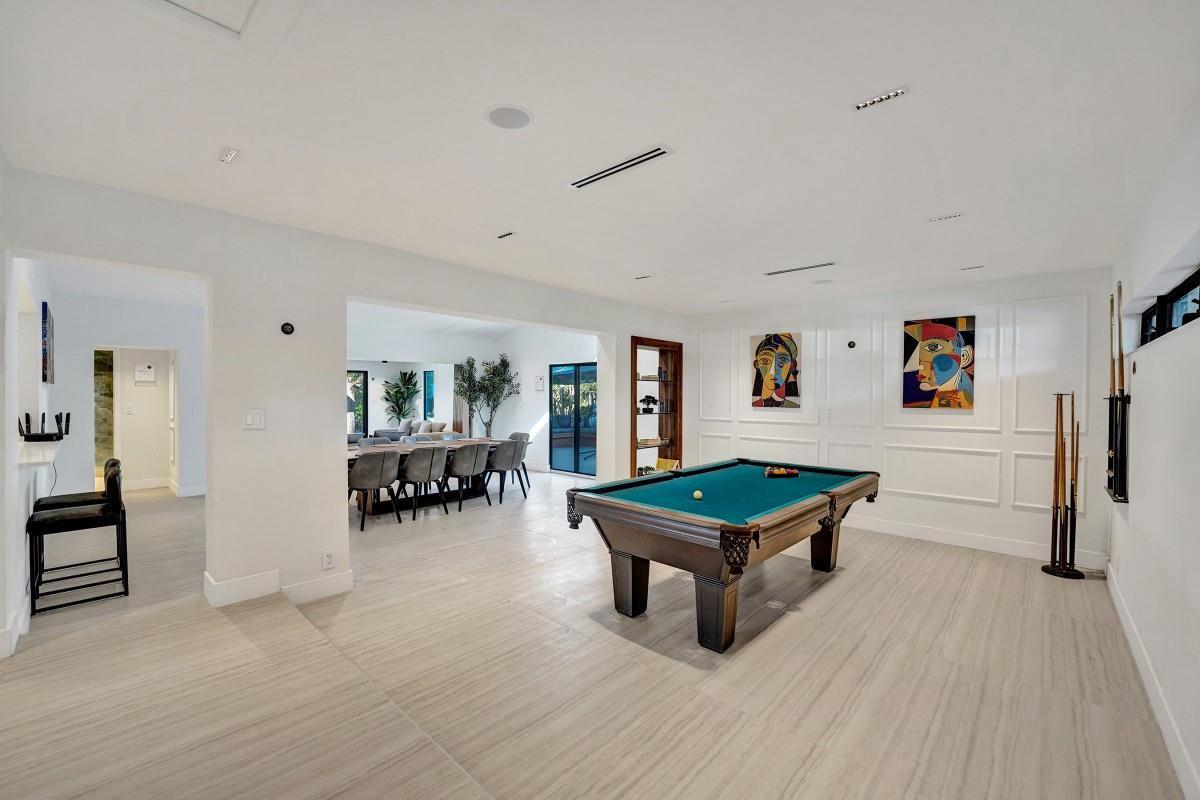 A game room with a pool table, wood-look tile flooring, and white paneled walls — 4417 SW 38th Terrace, Dania Beach FL 33312, DANIA BEACH, FL