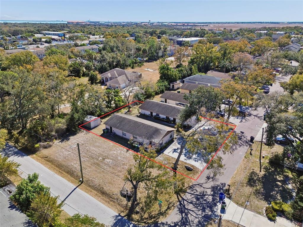 An aerial view shows two single-story residential buildings outlined in red on a grassy lot — 6404 S ADELIA AVENUE, TAMPA, FL