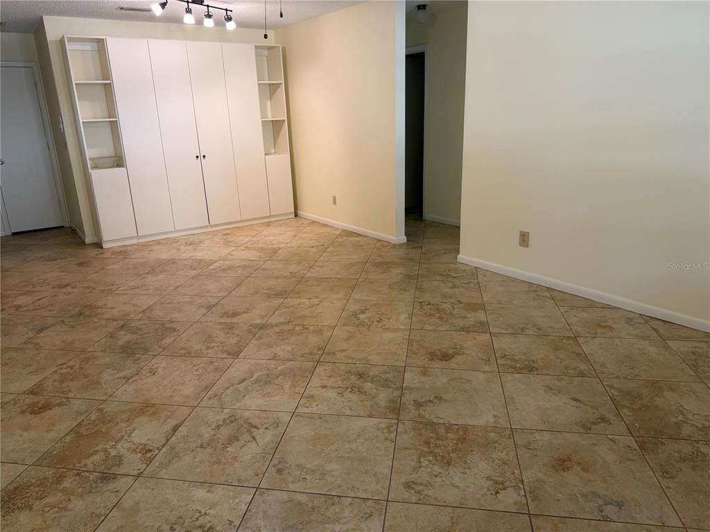 A room with beige tile flooring and a large white built-in storage unit — 9529 SW 85TH AVENUE UNIT D, OCALA, FL