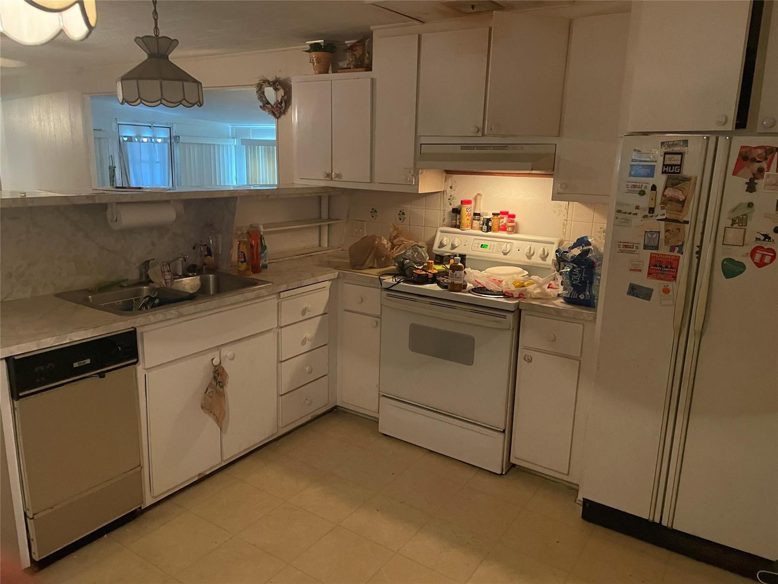 A kitchen with white cabinets, white appliances, a double sink, and light-colored laminate countertops — 8581 SW 20th Place, Davie FL 33324, DAVIE, FL