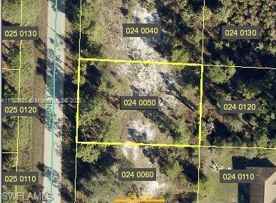 This is an aerial map view of a vacant, rectangular residential lot outlined in yellow — 941 Garnet Ave, Lehigh Acres FL 33974, LEHIGH ACRES, FL