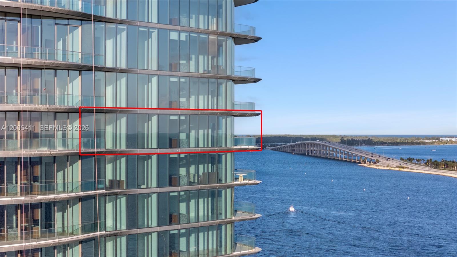 A high-rise building exterior features glass walls and balconies overlooking a bridge and water — 175 SE 25th Road # 1202, Miami FL 33129, MIAMI, FL