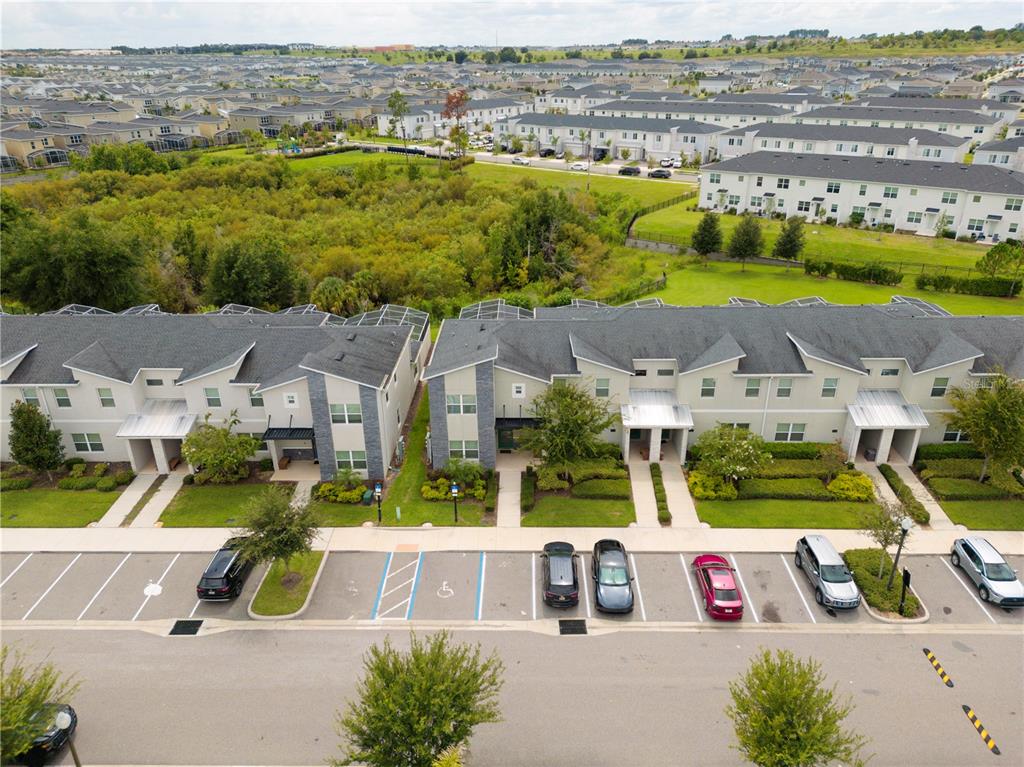 An aerial view shows a row of townhouses with parking spaces in front — 302 OCEAN COURSE AVENUE, DAVENPORT, FL