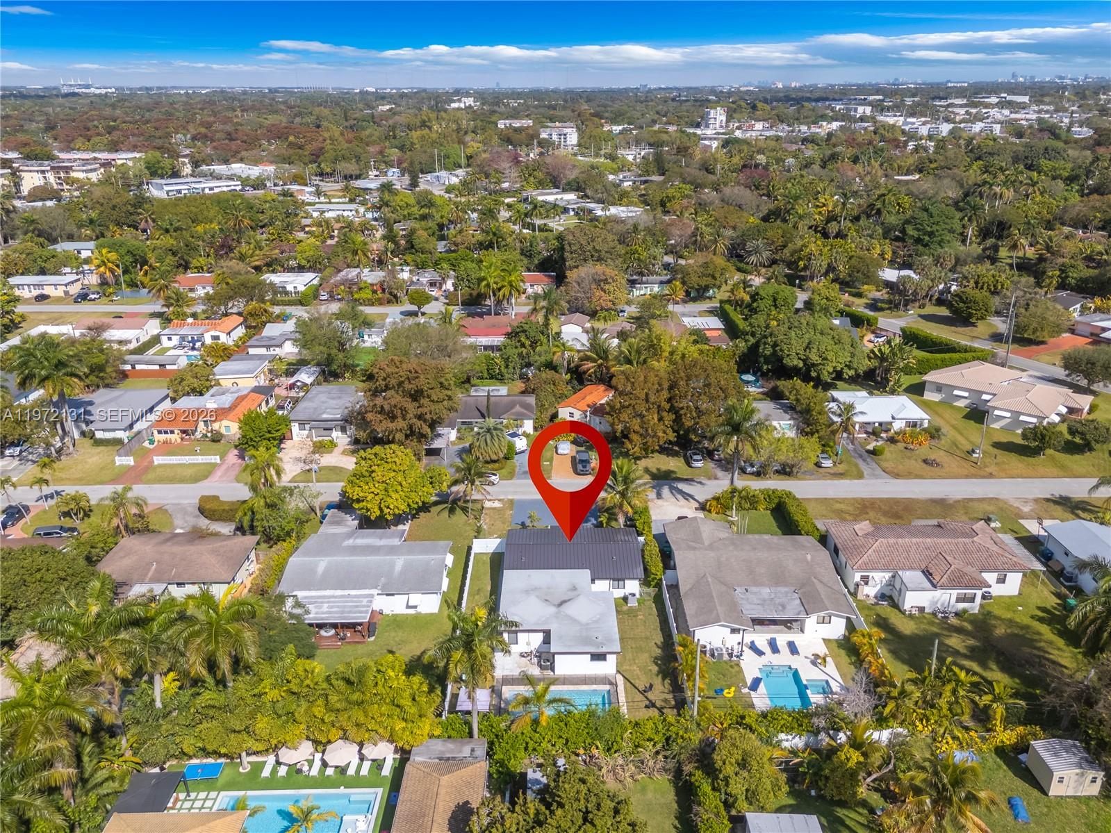 An aerial view shows a residential neighborhood with a house marked by a red pin — 348 NE 117th St, Miami FL 33161, MIAMI, FL