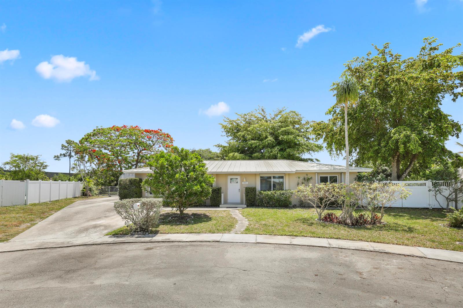 A single-story house with a metal roof and a paved driveway sits behind a lawn — 1720 SW 10th Street, Boca Raton FL 33486, BOCA RATON, FL
