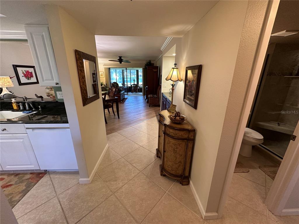 A tiled entryway leads to a kitchen, a dining area, and a bathroom — 760 AVENIDA ESTANCIA UNIT 217, VENICE, FL