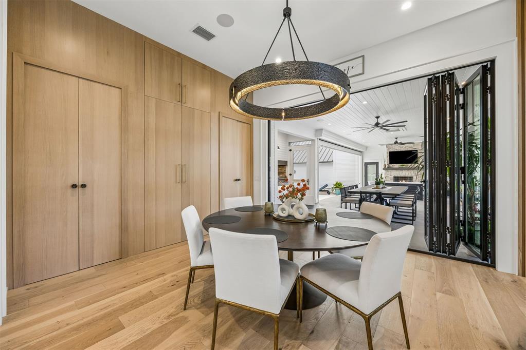 A dining room with light wood cabinetry, a round table, and folding doors to a patio — 52 Wallan Court, FL 32034, FL