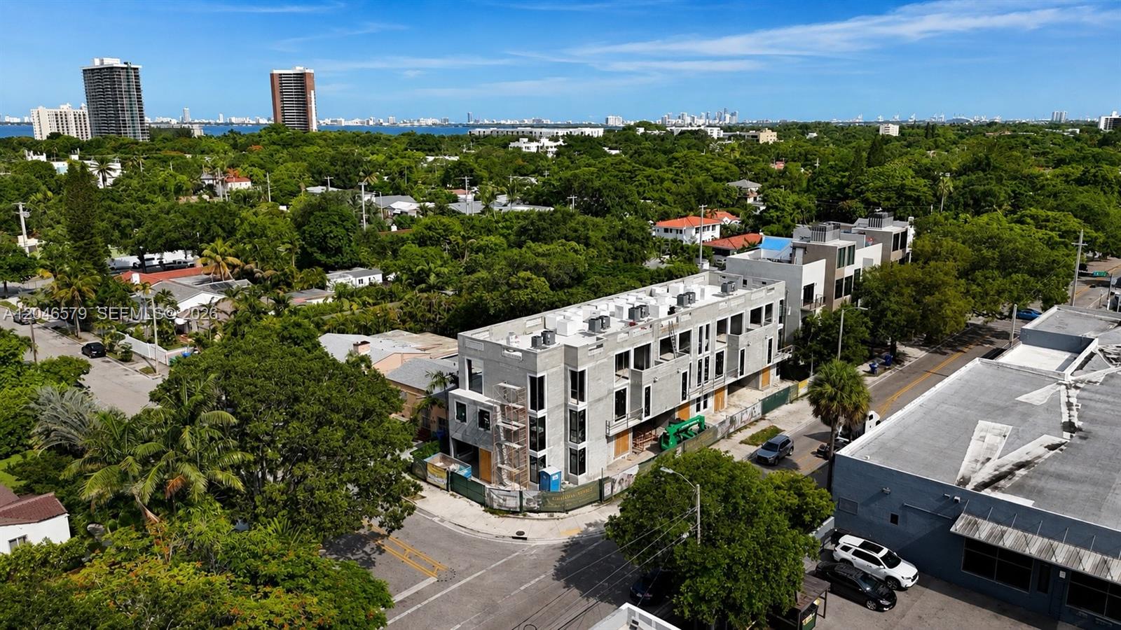 An aerial view shows a multi-story concrete residential building under construction near a street — 420 NE 72 # 4, Miami FL 33138, MIAMI, FL
