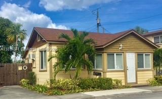 A single-story house with yellow siding, a brown roof, and a palm tree in front — 1416 N 2nd Ave N, Lake Worth FL 33460, LAKE WORTH, FL