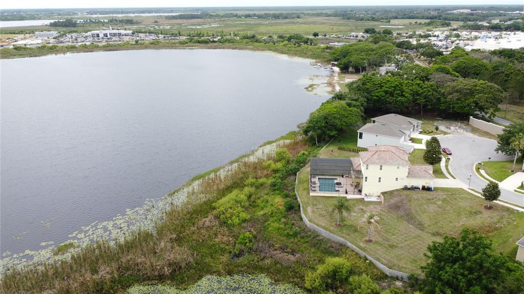 An aerial view shows a house with a pool near a large lake — 350 CHEROKEE AVE, HAINES CITY, FL