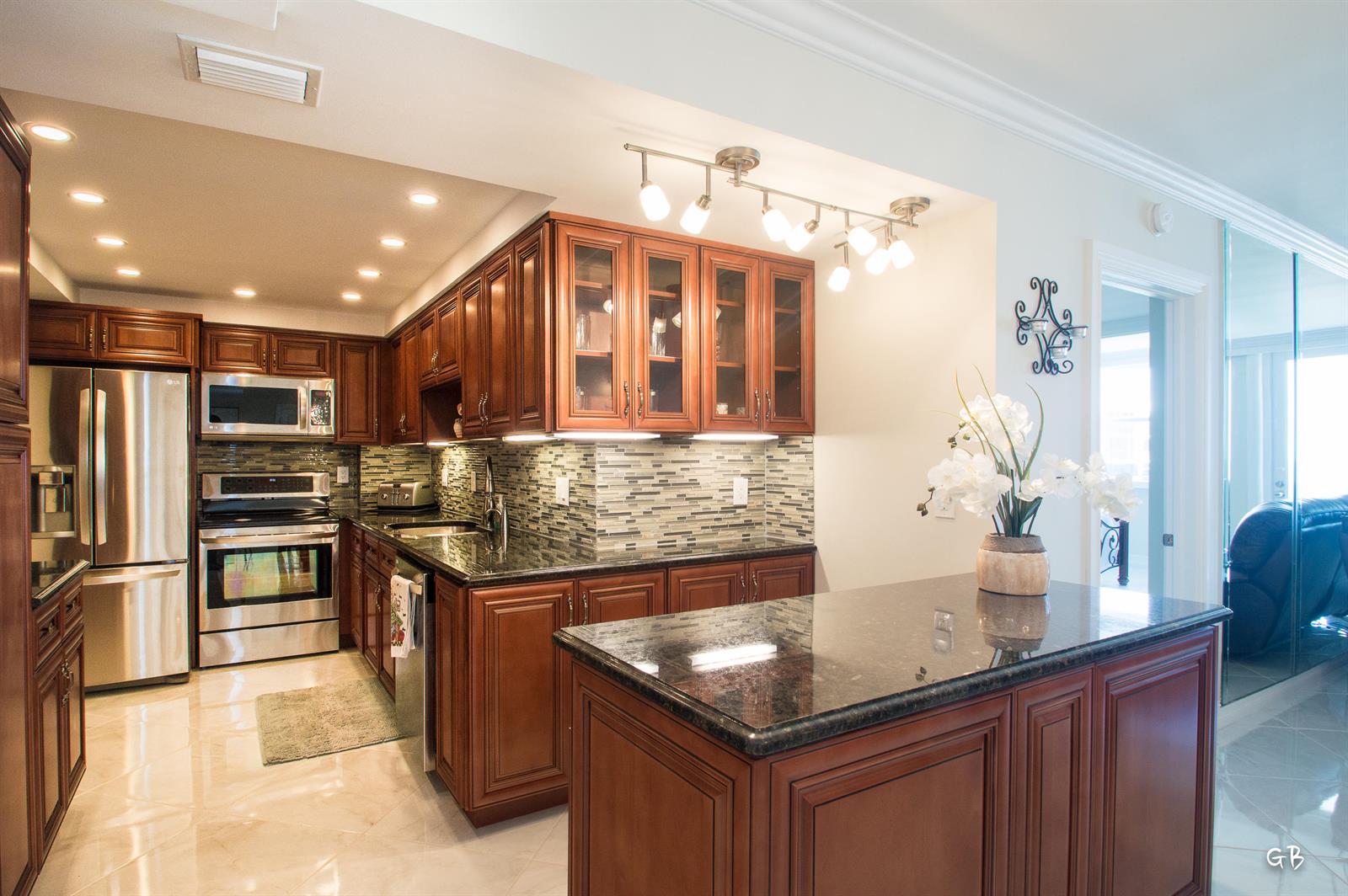 A kitchen with cherry wood cabinets, stainless steel appliances, granite countertops, and a center island — 3450 S Ocean Boulevard # 508, Palm Beach FL 33480, PALM BEACH, FL