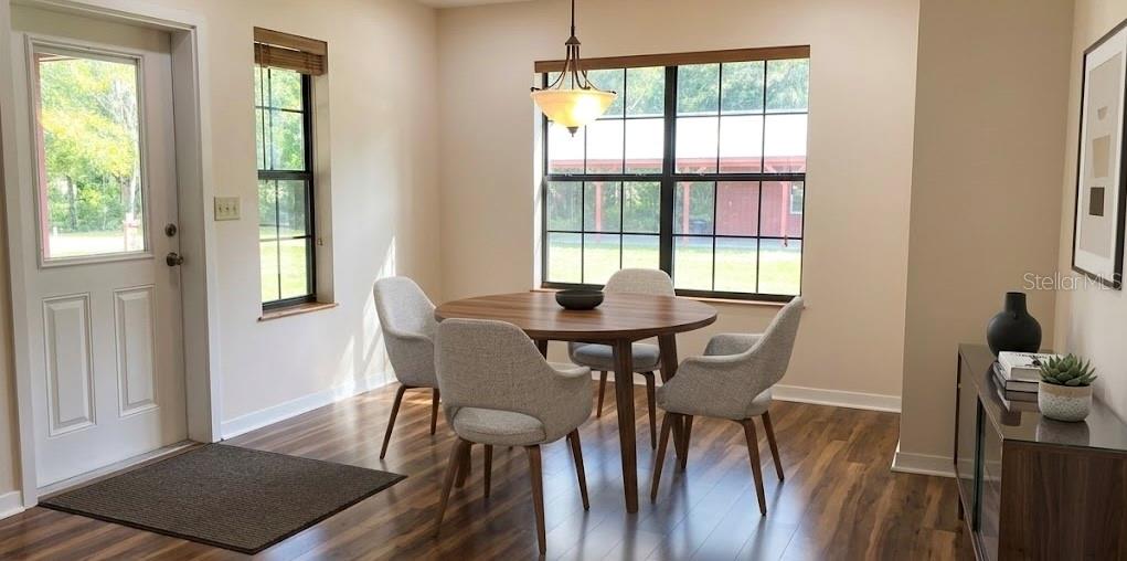 A dining area features a round wooden table, four chairs, and a glass-paned exterior door — 6611 SW 80TH AVENUE, OCALA, FL