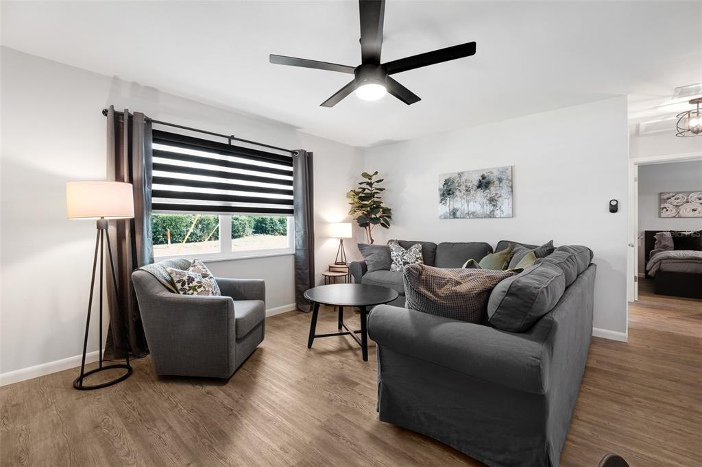 A living room features a gray sectional sofa, an armchair, and a ceiling fan — 2910 DADE AVENUE, ORLANDO, FL