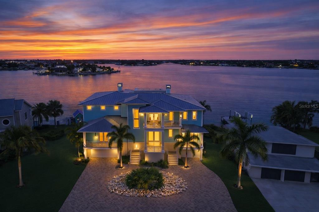 An aerial view of a multi-story waterfront house with a pool and private boat dock — 391 12TH AVENUE, INDIAN ROCKS BEACH, FL