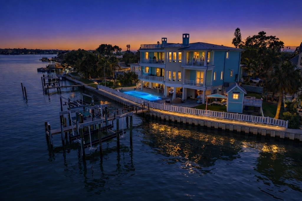 An elevated view of a sunset over a bay with a rooftop deck in foreground — 391 12TH AVENUE, INDIAN ROCKS BEACH, FL