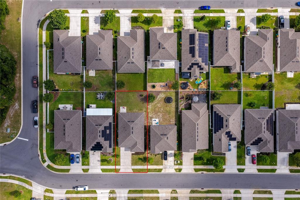 This aerial view shows a single-family home with a fenced backyard in a suburban neighborhood — 1514 PLAYWRIGHT DRIVE, DELAND, FL