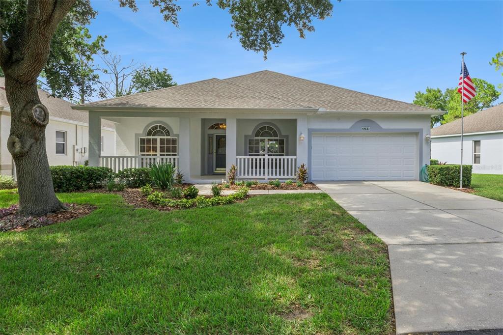 A screened-in patio features outdoor furniture, a ceiling fan, and a view of a golf course — 2284 ADDISON AVENUE, CLERMONT, FL