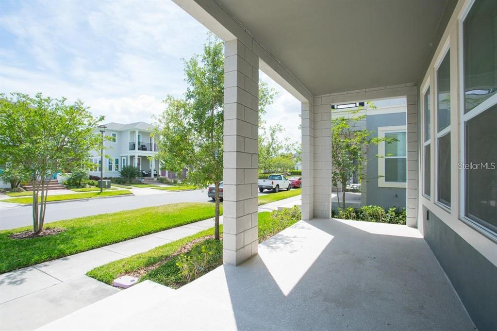 A blue front door with a glass panel sits at the top of white concrete stairs — 8543 PINTER STREET, ORLANDO, FL