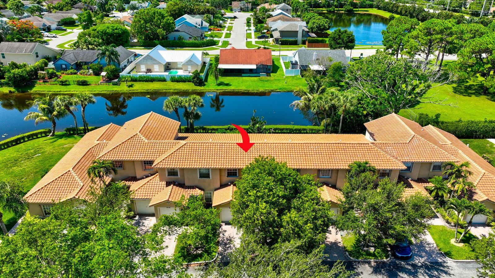 An aerial view of a multi-unit townhouse complex with a terracotta tile roof — 6374 Park Lake Circle, Boynton Beach FL 33437, BOYNTON BEACH, FL