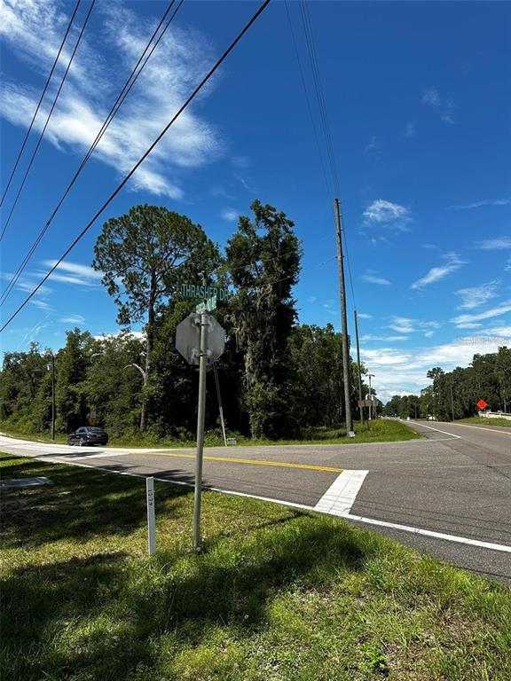 An outdoor view of a street intersection with a stop sign and road signs — xx THRASHER DR, BRONSON, FL