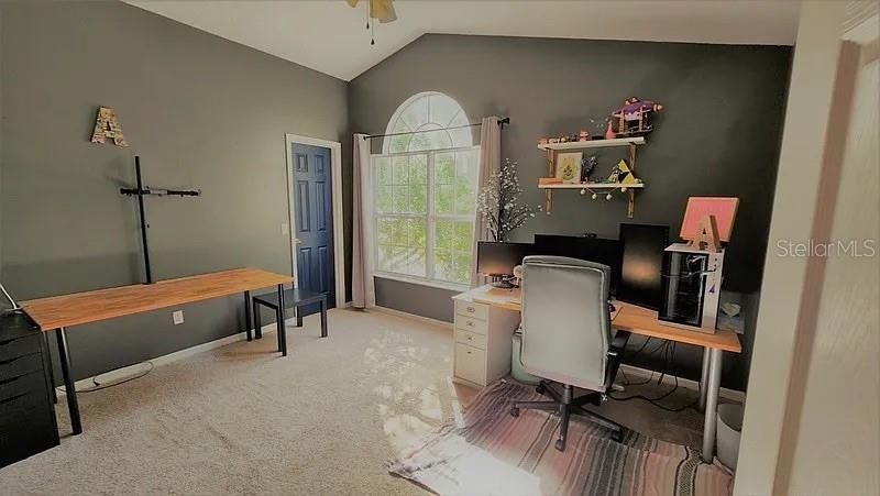 A home office features gray walls, a large arched window, and two wooden desks — 254 BRIDGE CREEK BOULEVARD, OCOEE, FL