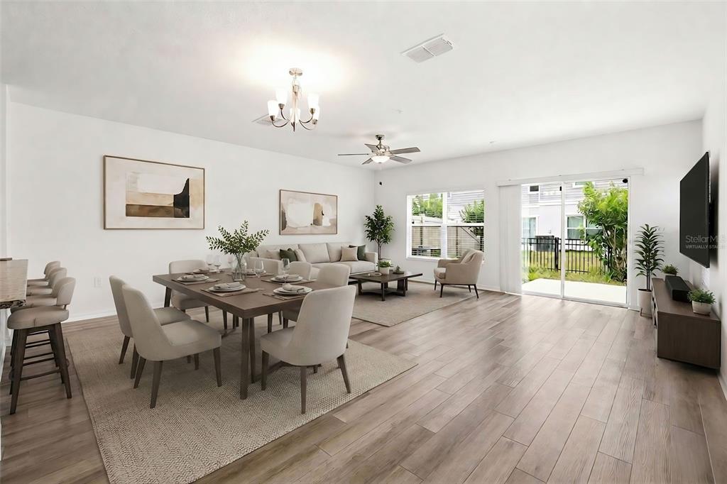 This is a virtually staged open-concept living and dining area with wood-look flooring — 2274 CARRABELLE WAY, SANFORD, FL